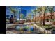 Modern shopping center with palm trees and a reflecting pool at 600 N Carriage Hill Dr # 1113, Las Vegas, NV 89138