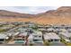 Beautiful aerial view of the home nestled in a community with pools and mountain views at 6800 Equinox Cliff St, Las Vegas, NV 89135