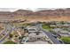 Aerial view showing a community of homes nestled in a desert landscape at 6800 Equinox Cliff St, Las Vegas, NV 89135