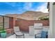 This outdoor kitchen features a built-in grill, perfect for enjoying the beautiful backyard and mountain views at 6800 Equinox Cliff St, Las Vegas, NV 89135