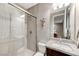 This bathroom has a glass shower and a modern sink with a large mirror at 6800 Equinox Cliff St, Las Vegas, NV 89135