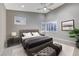 Bedroom featuring a tufted headboard, shutters on the windows, and a modern aesthetic at 6800 Equinox Cliff St, Las Vegas, NV 89135