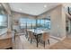 Bright dining room features a modern table, seating for six, and large windows with a lovely outdoor view at 6800 Equinox Cliff St, Las Vegas, NV 89135