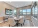 Elegant dining room with modern furniture, large windows, and stylish decor at 6800 Equinox Cliff St, Las Vegas, NV 89135