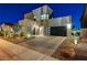 Stunning two-story home featuring modern design, stone accents, and desert landscaping at 6800 Equinox Cliff St, Las Vegas, NV 89135