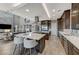 Open concept kitchen with an island cooktop, sleek cabinetry, and a seamless connection to the living space at 6800 Equinox Cliff St, Las Vegas, NV 89135