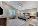 Spacious main bedroom with a vaulted ceiling, large windows, ceiling fan, and comfortable furnishings at 6800 Equinox Cliff St, Las Vegas, NV 89135