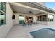 Relaxing covered patio with outdoor seating area, ceiling fan, and a view of the pool at 6800 Equinox Cliff St, Las Vegas, NV 89135