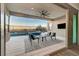 Spacious outdoor patio area with seating, a TV, and a view of the pool and mountains at 6800 Equinox Cliff St, Las Vegas, NV 89135