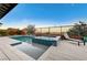 This backyard features a refreshing pool and spa combo, perfect for relaxing and entertaining at 6800 Equinox Cliff St, Las Vegas, NV 89135