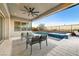 Inviting outdoor living space with a pool, spa, and comfortable seating area at 6800 Equinox Cliff St, Las Vegas, NV 89135