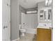 Bright bathroom featuring a shower-tub combo, single vanity, and neutral tile flooring at 6953 Graceful Cloud, Henderson, NV 89011