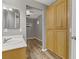 Bathroom with laminate floors, light cabinets, and a vanity with sink at 6953 Graceful Cloud, Henderson, NV 89011