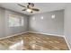 Bright bedroom with neutral walls, hardwood floors, and a ceiling fan for optimal comfort at 6953 Graceful Cloud, Henderson, NV 89011