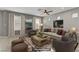 Staged living room showcases neutral walls, comfortable seating, and a stylish area rug at 6953 Graceful Cloud, Henderson, NV 89011