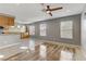 Open living space with ceiling fan, recessed lights, and wood-look flooring transition to tile at 6953 Graceful Cloud, Henderson, NV 89011