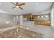Open living space showing staircase, living room, and kitchen with stainless steel appliances at 6953 Graceful Cloud, Henderson, NV 89011