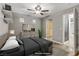 Staged primary bedroom with modern furniture, neutral walls, and access to the ensuite bathroom at 6953 Graceful Cloud, Henderson, NV 89011