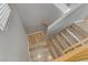 Staircase with wood treads and white risers, complemented by wood-look floors at the landing at 6953 Graceful Cloud, Henderson, NV 89011
