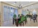 Dining room with large windows, plantation shutters, and mirrored wall detail at 8390 Carmel Ridge Ct, Las Vegas, NV 89113