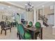 Bright dining room with a statement chandelier, open floor plan, and staircase at 8390 Carmel Ridge Ct, Las Vegas, NV 89113