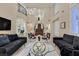 Inviting living room featuring high ceilings and a staircase at 8390 Carmel Ridge Ct, Las Vegas, NV 89113