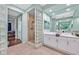 Beautifully designed main bathroom with walk-in shower with glass block, dual sinks, and plenty of vanity space at 8390 Carmel Ridge Ct, Las Vegas, NV 89113