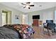 A large, beautifully decorated main bedroom featuring hardwood floors, a ceiling fan, and plenty of natural light at 8390 Carmel Ridge Ct, Las Vegas, NV 89113