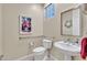 Traditional powder room with pedestal sink and decorative mirror at 8390 Carmel Ridge Ct, Las Vegas, NV 89113