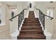 Beautiful staircase with wooden steps and ornate iron railing at 8390 Carmel Ridge Ct, Las Vegas, NV 89113