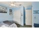 Blue bedroom with closet and door to hallway at 1179 King Arthur Ct, Henderson, NV 89002