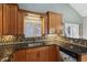 Cozy kitchen featuring granite counters, a stainless steel sink, custom cabinets and a dishwasher with a floral design at 1179 King Arthur Ct, Henderson, NV 89002