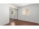 Bright bedroom featuring wood floors, ample natural light, and mirrored closet at 338 Jett St # 101, Las Vegas, NV 89145