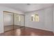 Bright bedroom featuring wood floors, ample natural light, and mirrored closet at 338 Jett St # 101, Las Vegas, NV 89145