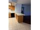 Kitchen featuring oak cabinets, black appliances, tile flooring, and peninsula at 338 Jett St # 101, Las Vegas, NV 89145
