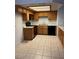 Well lit kitchen featuring oak cabinets, black appliances, and tile flooring at 338 Jett St # 101, Las Vegas, NV 89145
