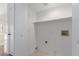 Functional laundry room with connections for a washer and dryer, painted bright white at 338 Jett St # 101, Las Vegas, NV 89145