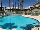 Community pool area with palm trees and lounge seating at 338 Jett St # 101, Las Vegas, NV 89145