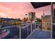 City view from balcony with sidewalks and street, and a colorful skyline with pink clouds at 353 E Bonneville Ave # 313, Las Vegas, NV 89101