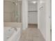 Bathroom featuring a glass-enclosed shower and access to the walk-in closet at 353 E Bonneville Ave # 313, Las Vegas, NV 89101