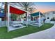 Modern cabanas with lounge seating surrounded by artificial turf and palm trees at 353 E Bonneville Ave # 313, Las Vegas, NV 89101