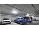 Bright parking garage featuring ample space with several cars parked neatly in their respective spots at 353 E Bonneville Ave # 313, Las Vegas, NV 89101