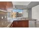 Stylish kitchen featuring stainless steel appliances, granite countertops, and wood cabinetry at 353 E Bonneville Ave # 313, Las Vegas, NV 89101