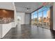 Bright living room with hardwood floors, concrete accent wall and floor to ceiling windows with city views at 353 E Bonneville Ave # 313, Las Vegas, NV 89101