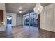Spacious living area with modern light fixture, hardwood floors, and floor-to-ceiling windows at 353 E Bonneville Ave # 313, Las Vegas, NV 89101