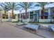Upscale pool area surrounded by lush palm trees and comfortable lounging furniture at 353 E Bonneville Ave # 313, Las Vegas, NV 89101