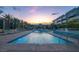 Serene community pool at dusk, surrounded by lounge chairs and modern architecture at 353 E Bonneville Ave # 313, Las Vegas, NV 89101