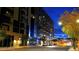 Evening shot of sleek modern building with illuminated balconies and stylish architecture at 353 E Bonneville Ave # 313, Las Vegas, NV 89101