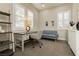 Bright home office features built-in shelving and a comfortable seating area at 5864 Sky Ridge Falls Dr, Las Vegas, NV 89135