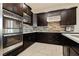 Modern kitchen with stainless steel appliances and dark wood cabinetry at 5864 Sky Ridge Falls Dr, Las Vegas, NV 89135